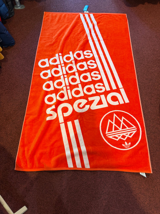 Full view of adidas Spezial towel in orange and off white