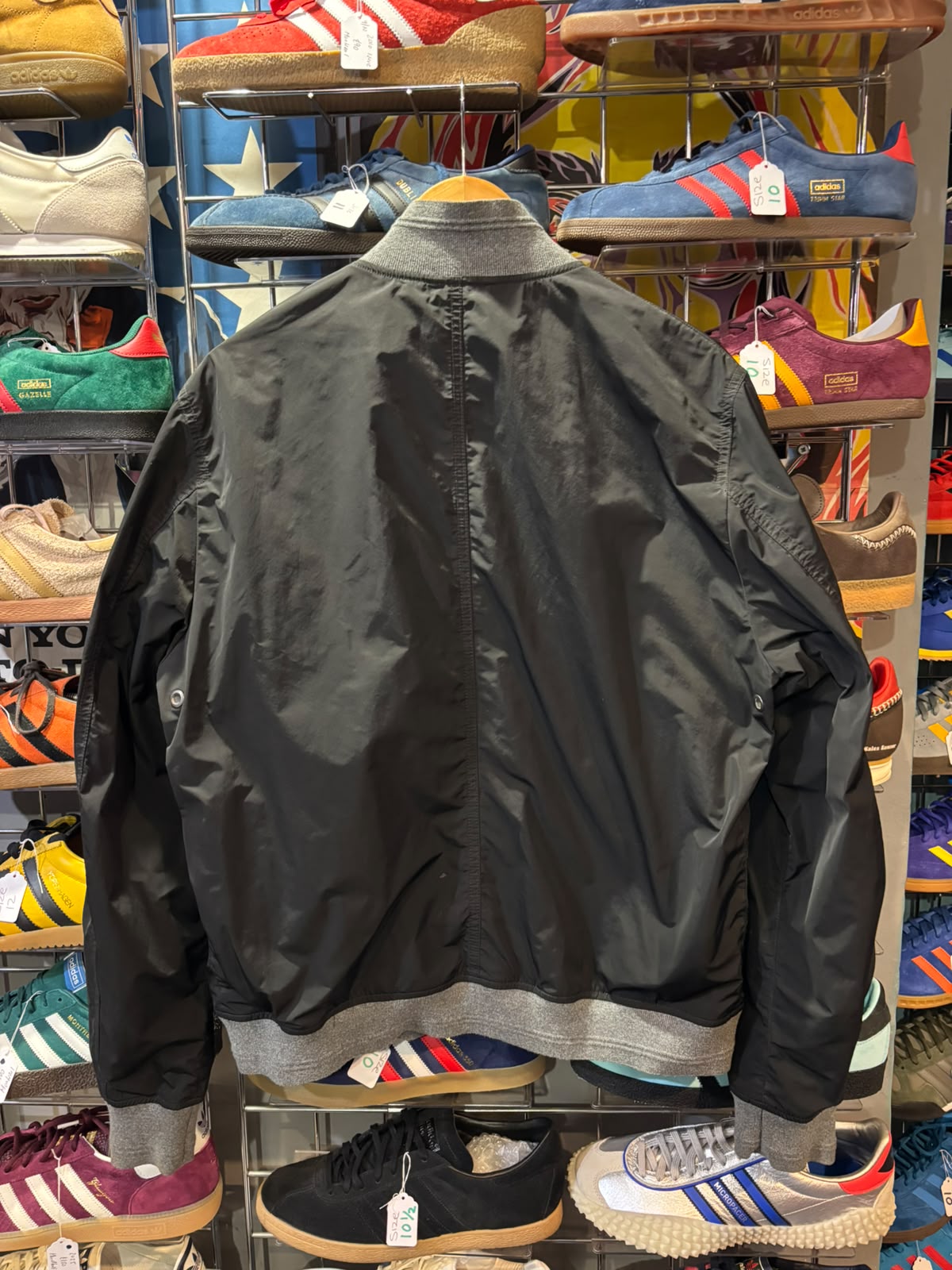 Back view of black Belstaff jacket with grey ribbed trim